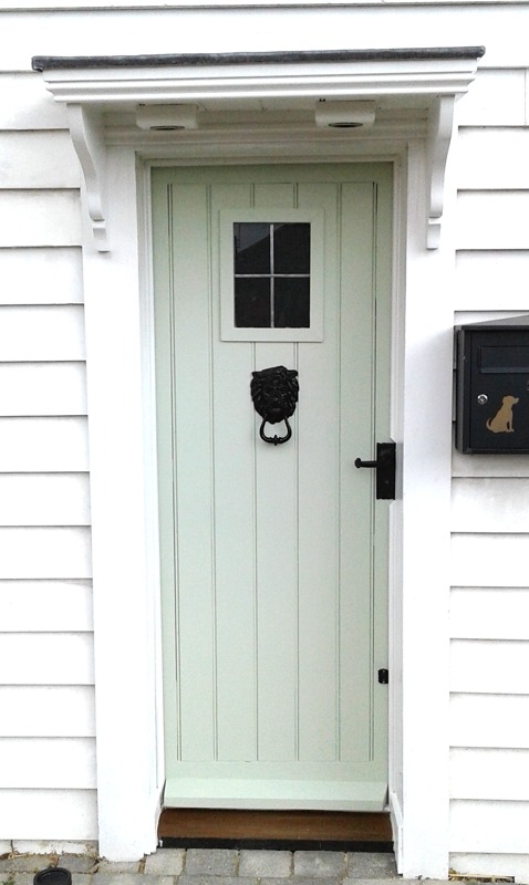 Pale green toungue and groove front door with window and black fittings