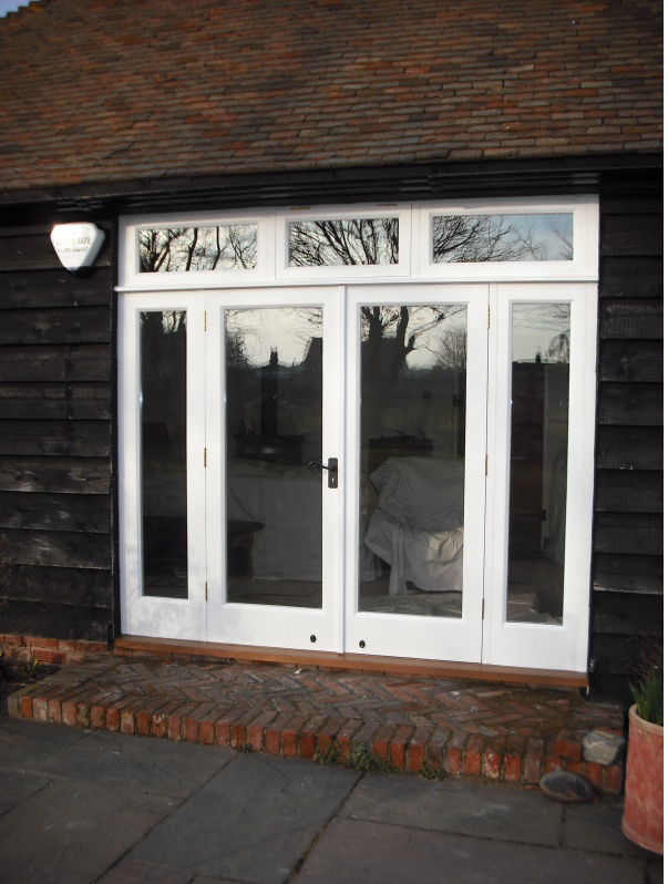 bespoke white patio doors and window surrounds in barn conversion
