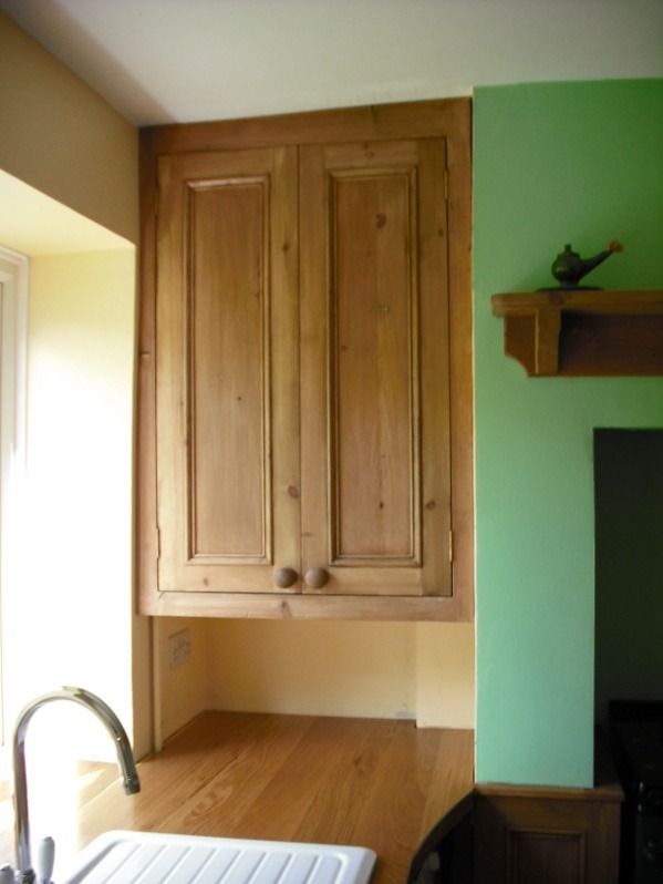 Bespoke antique pine wall unit in alcove