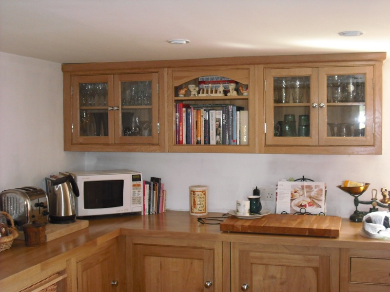 Bespoke mid wood wall units, glass fronted