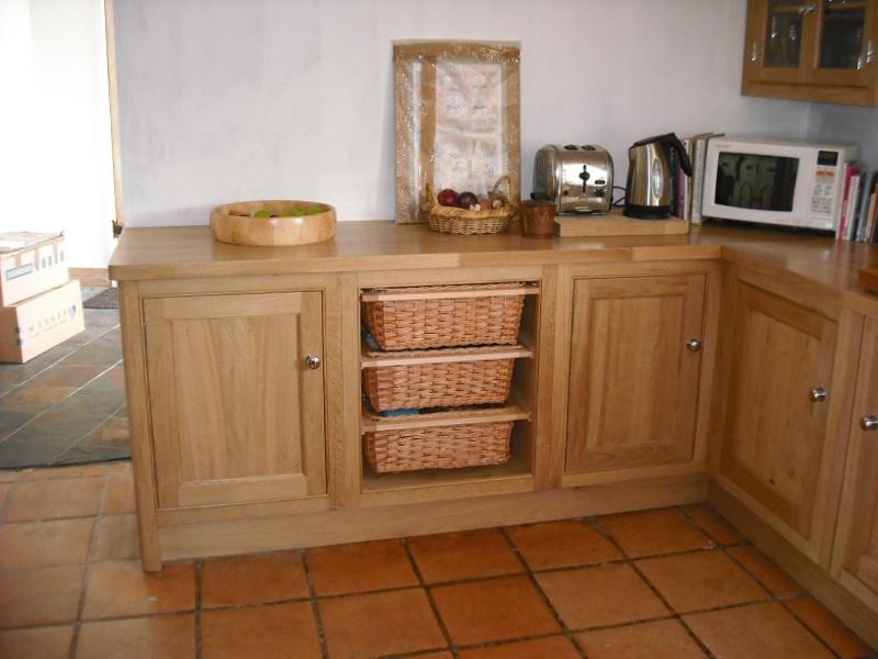 Bespoke mid wood kitchen floor units with baskets
